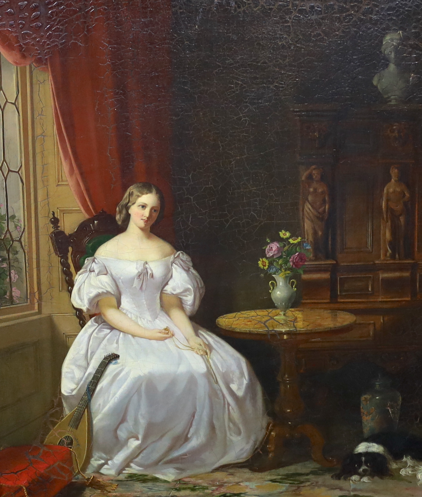 19th century English School , Interior with seated lady holding a pendant on chain, a spaniel at her feet, oil on canvas, 60 x 50cm